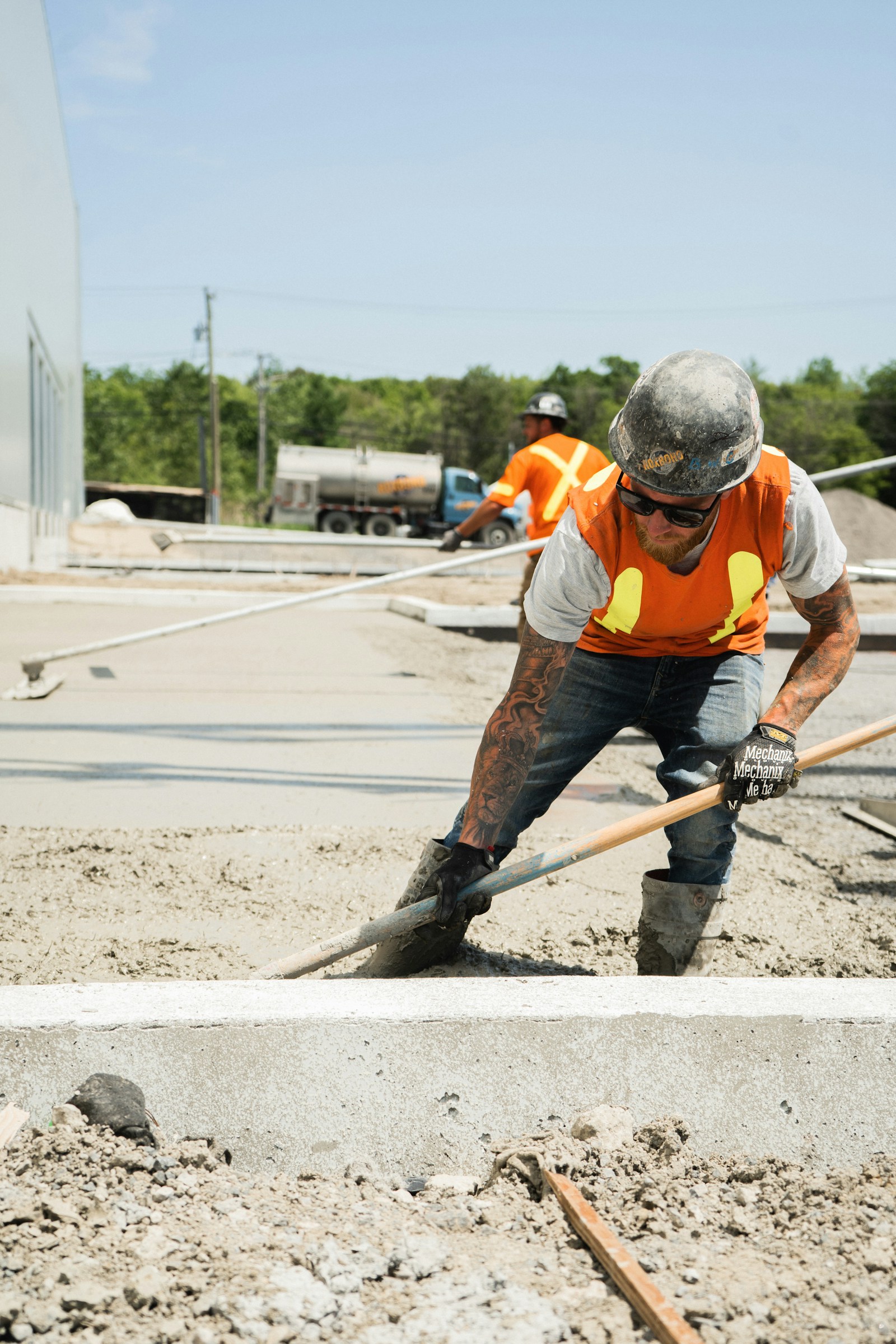 Concrete crew placing and raking a fresh pour