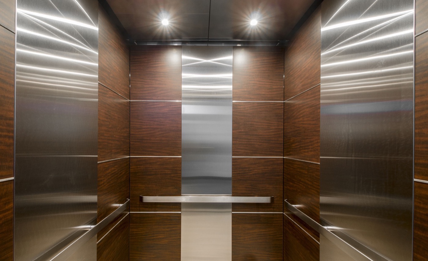Refinished stainless steel and wood elevator cabin interior